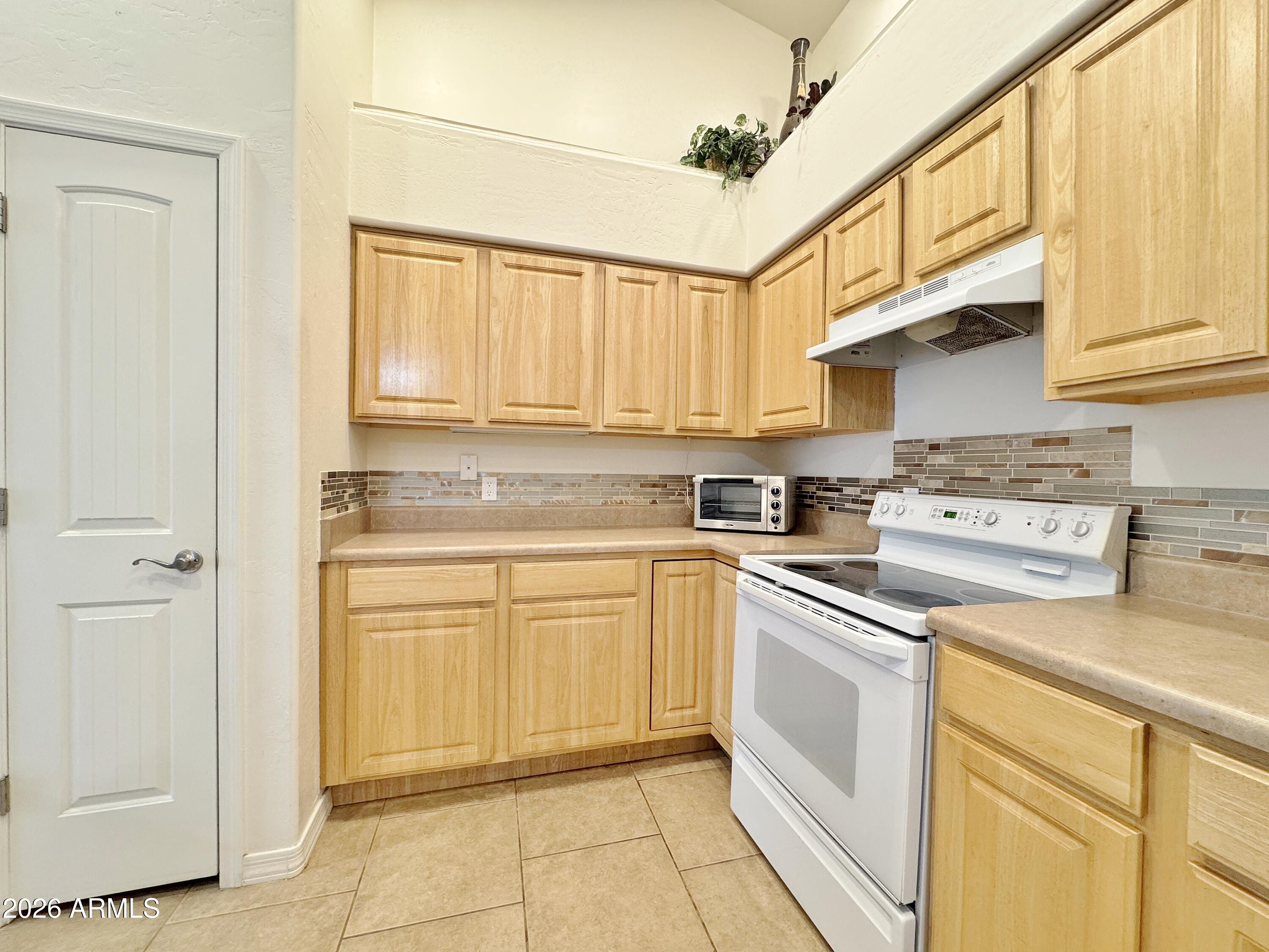 15774 South Saxon Road Arizona City, AZ 85123 - Photo 17 of 53 a kitchen with cabinets appliances and a window