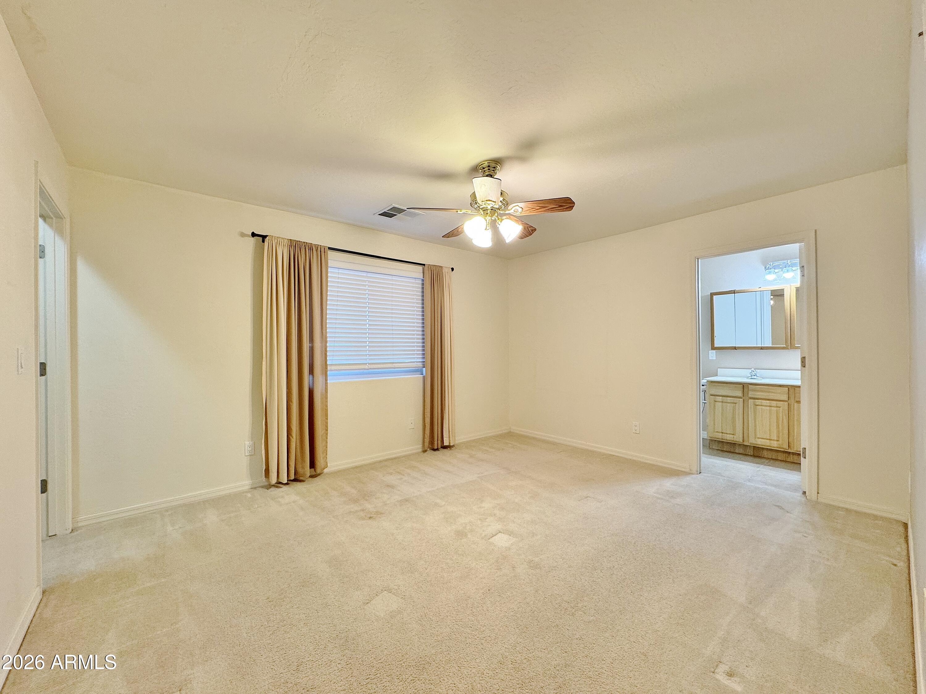 15774 South Saxon Road Arizona City, AZ 85123 - Photo 18 of 53 a view of an empty room with a chandelier fan