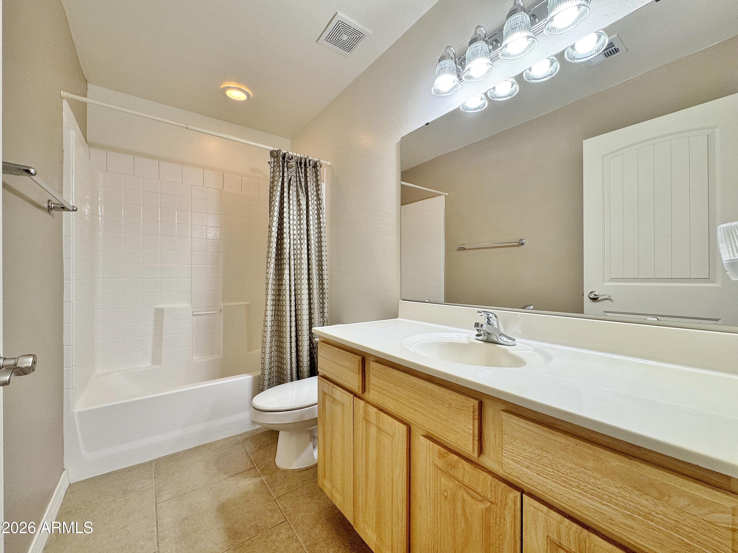 15774 South Saxon Road Arizona City, AZ 85123 - Photo 27 of 53 a spacious bathroom with a sink a toilet a mirror and shower