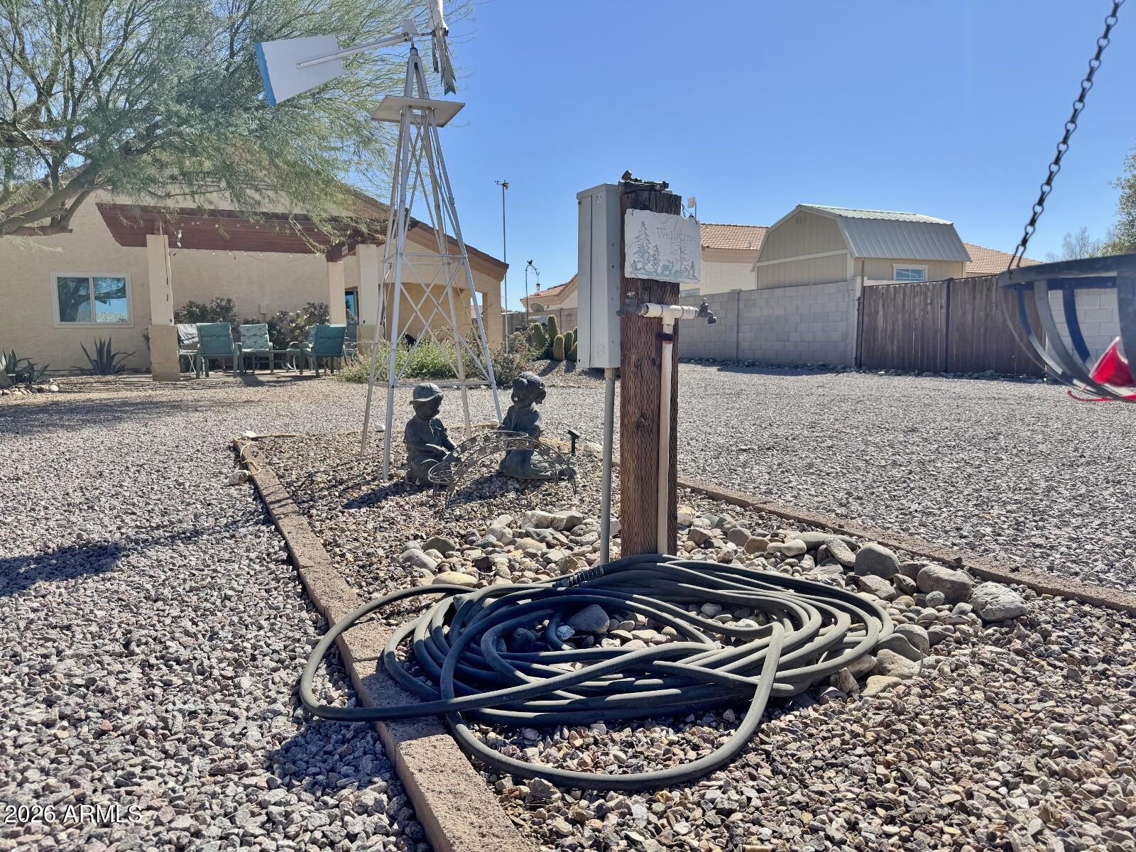 15774 South Saxon Road Arizona City, AZ 85123 - Photo 50 of 53 a view of a wooden house with a yard