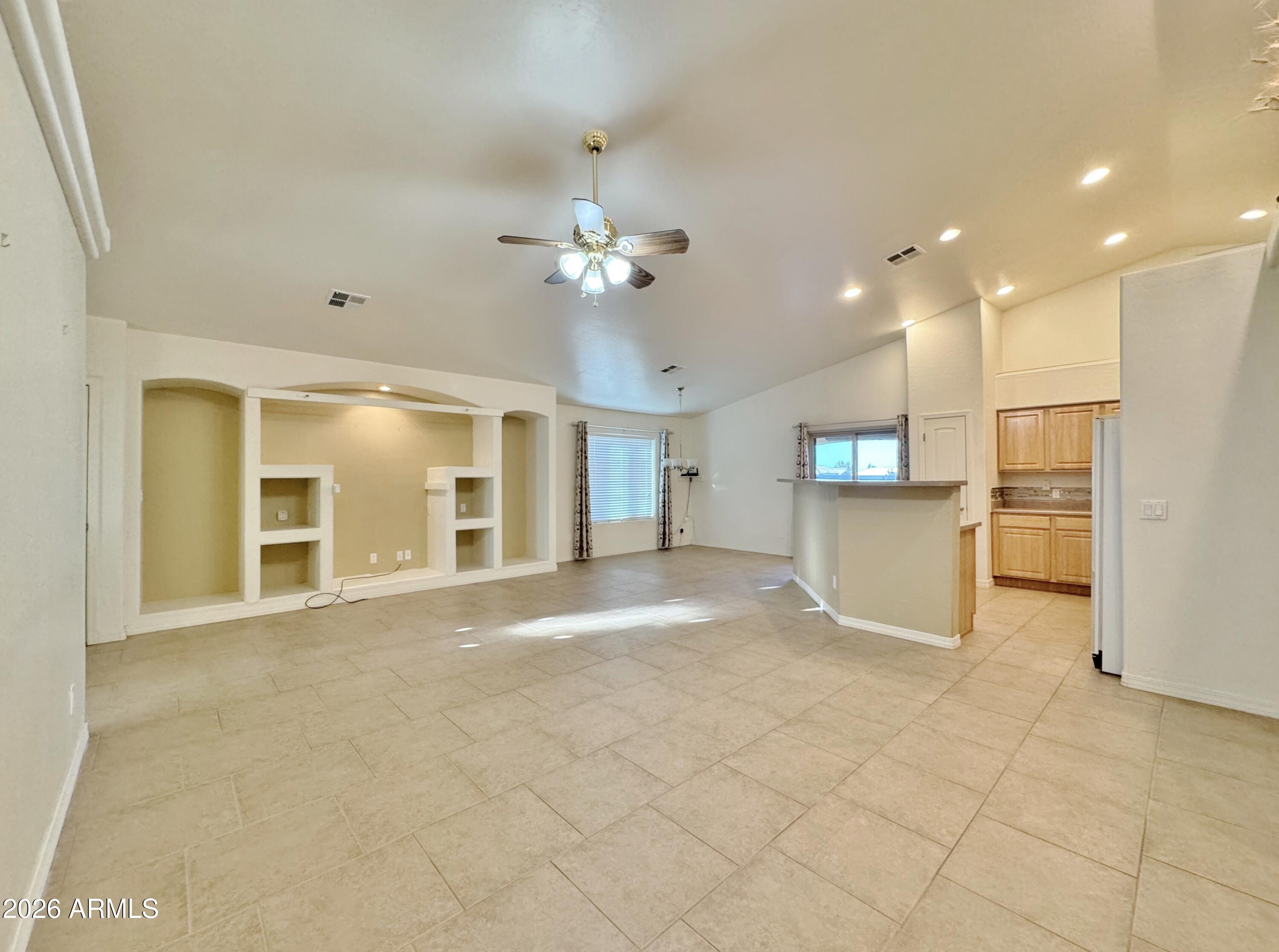 15774 South Saxon Road Arizona City, AZ 85123 - Photo 8 of 53 a view of an empty room with kitchen view and a window