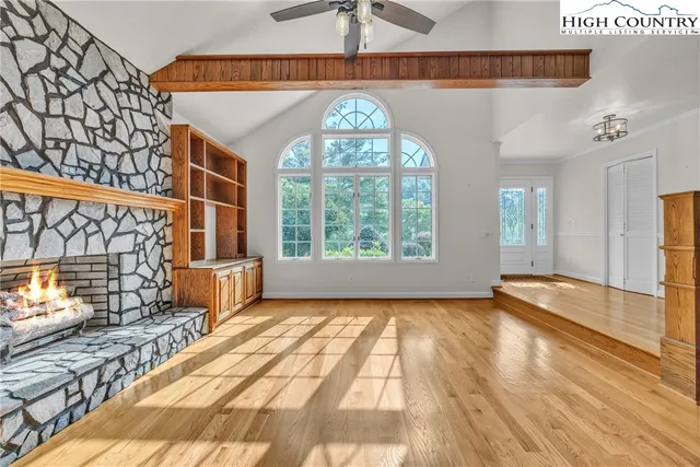 a view of a room with window and wooden floor
