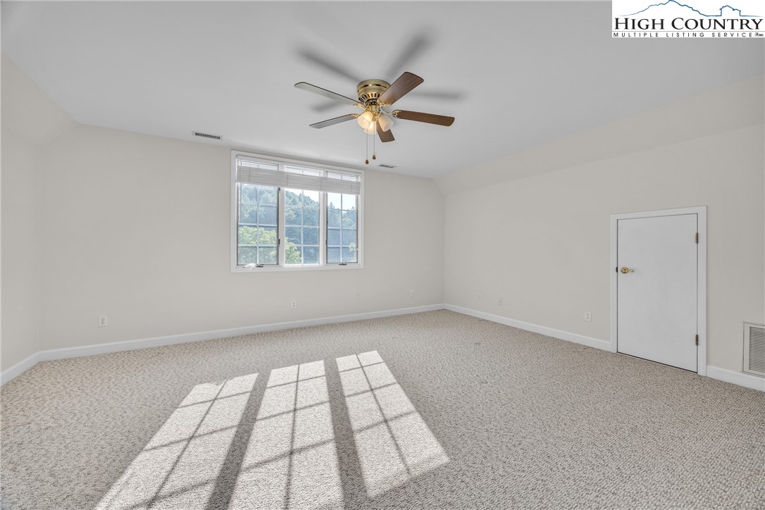 1515 Clifton Road Crumpler, NC 28617 - Photo 14 of 23 an empty room with windows and fan