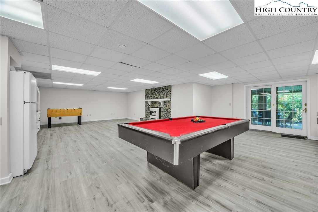 1515 Clifton Road Crumpler, NC 28617 - Photo 16 of 23 a room with pool table windows and wooden floor