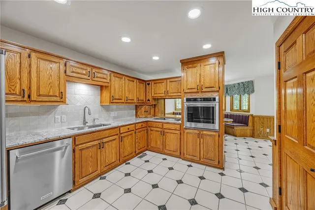 a kitchen with stainless steel appliances granite countertop a sink and cabinets