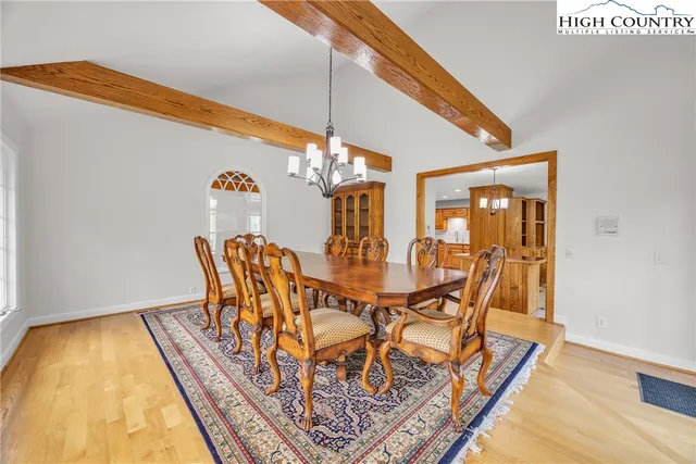 a dining room with furniture and wooden floor