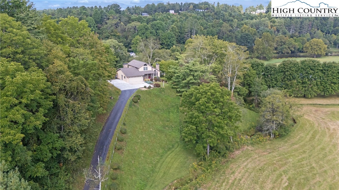 1515 Clifton Road Crumpler, NC 28617 - Photo 2 of 23 a aerial view of a house with a yard basket ball court and outdoor seating