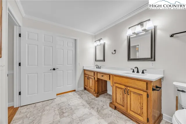 a bathroom with a sink a toilet a mirror and vanity