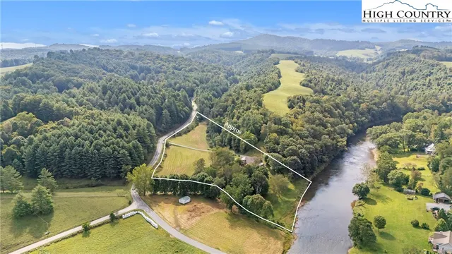 a view of a swimming pool with a yard and mountain view
