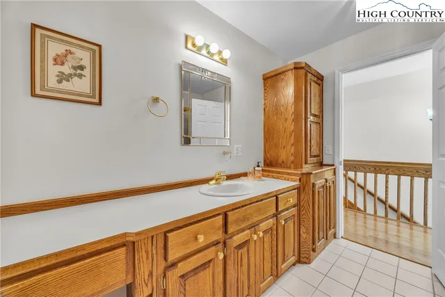 a bathroom with a sink a mirror and a shower