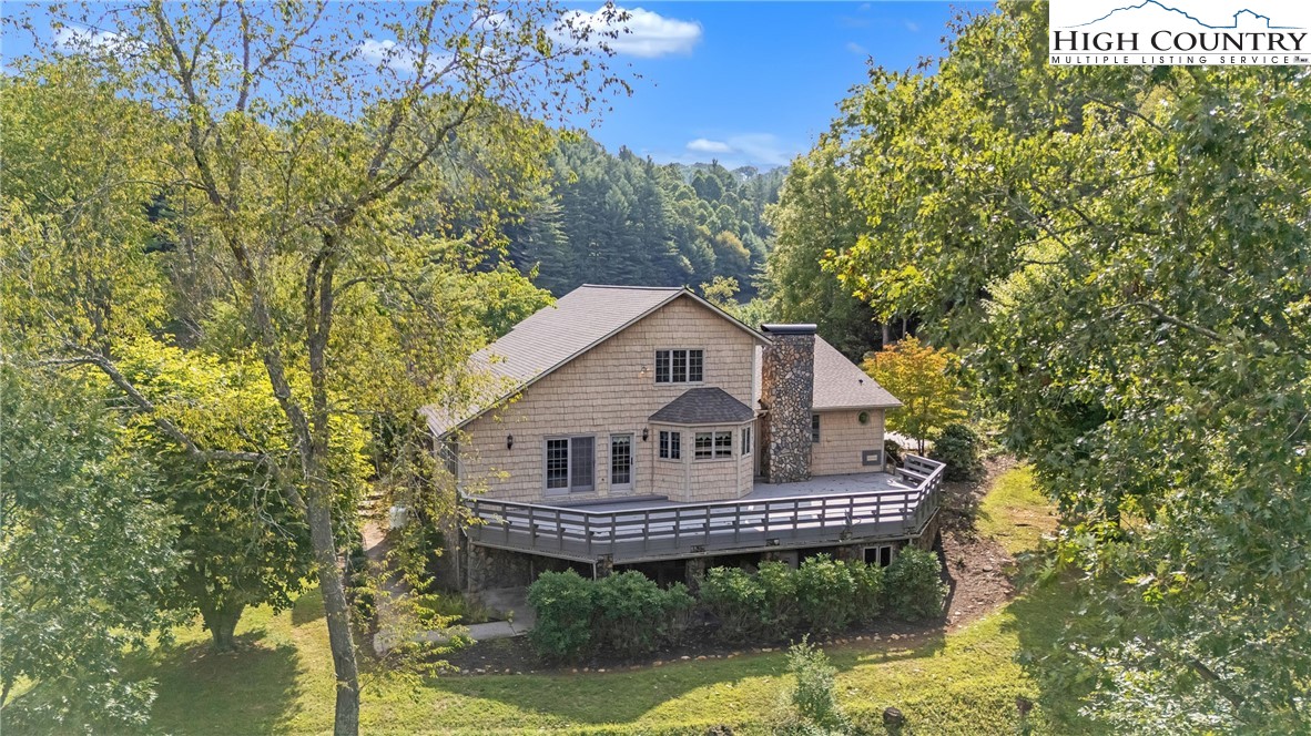 1515 Clifton Road Crumpler, NC 28617 - Photo 5 of 23 a view of a house with a small yard plants and large tree