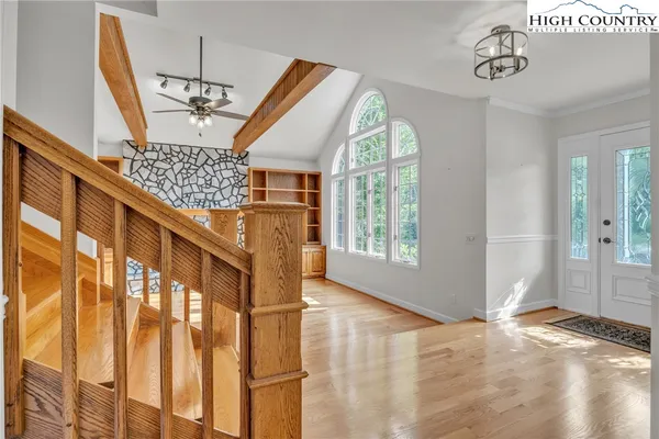 a view of entryway and hall with wooden floor