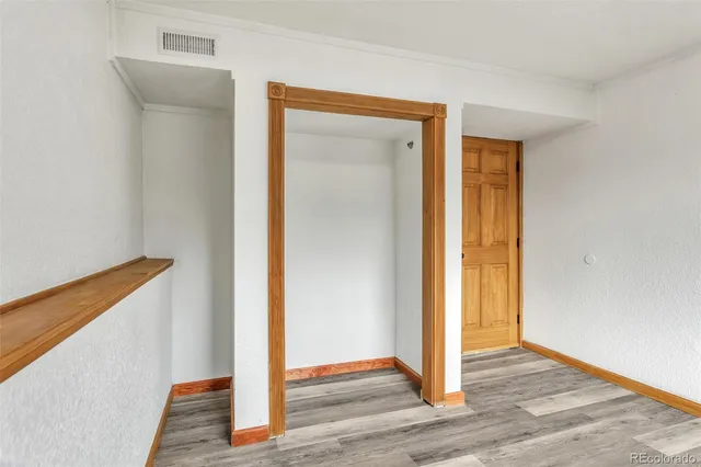a view of a hallway with wooden floor