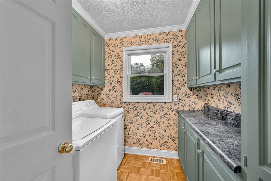 1016 Campbell Road Belton, SC 29627 - Photo 20 of 50 Functional laundry room offers upper and lower cabinetry, ample counter space, and window views.