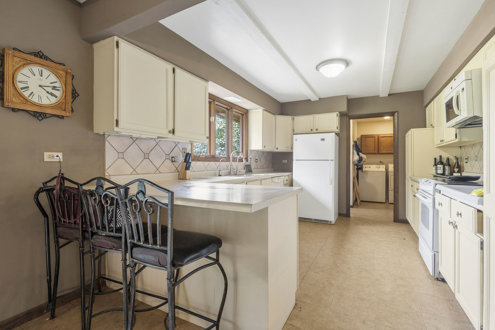 1010 Sunset Road Spring Grove, IL 60081 - Photo 24 of 40 a kitchen with refrigerator cabinets and a sink