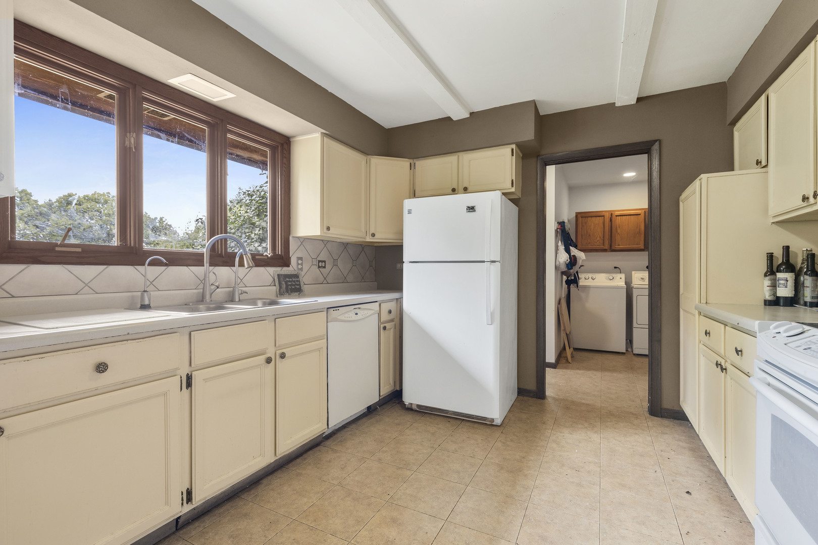 1010 Sunset Road Spring Grove, IL 60081 - Photo 25 of 40 a kitchen with white cabinets and white appliances