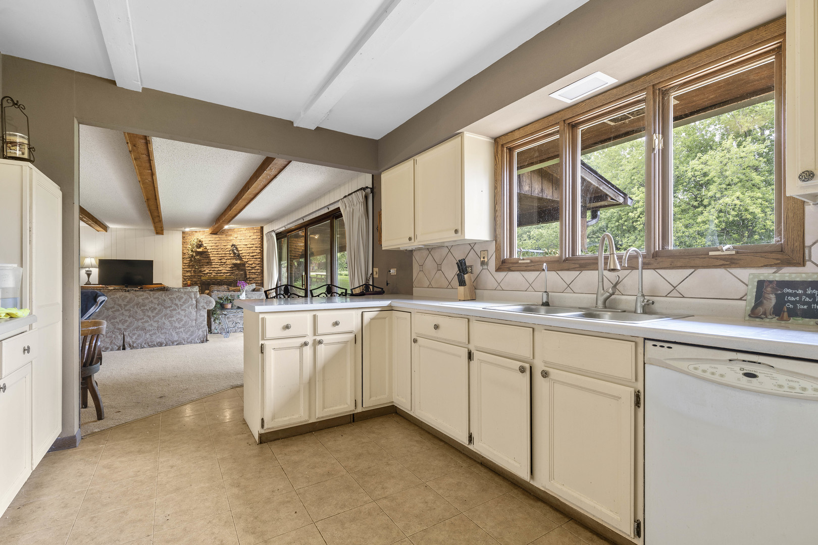 1010 Sunset Road Spring Grove, IL 60081 - Photo 26 of 40 a kitchen with white cabinets and a large window