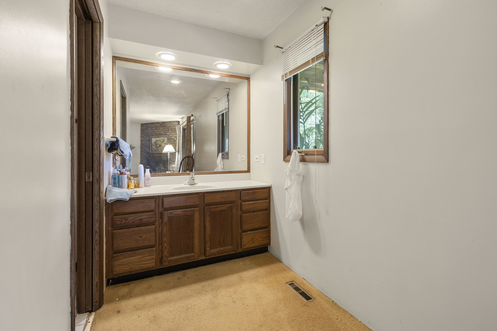 1010 Sunset Road Spring Grove, IL 60081 - Photo 29 of 40 a bathroom with a double vanity sink and mirror with window