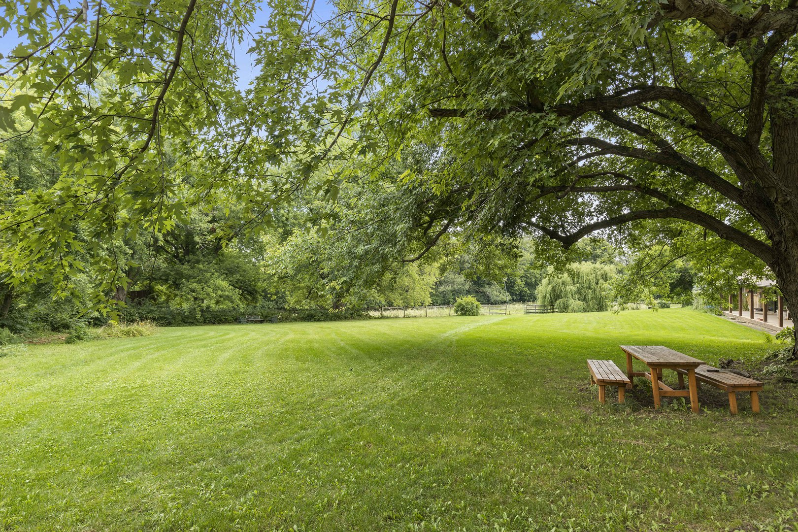 1010 Sunset Road Spring Grove, IL 60081 - Photo 6 of 40 a view of a green field with wooden fence