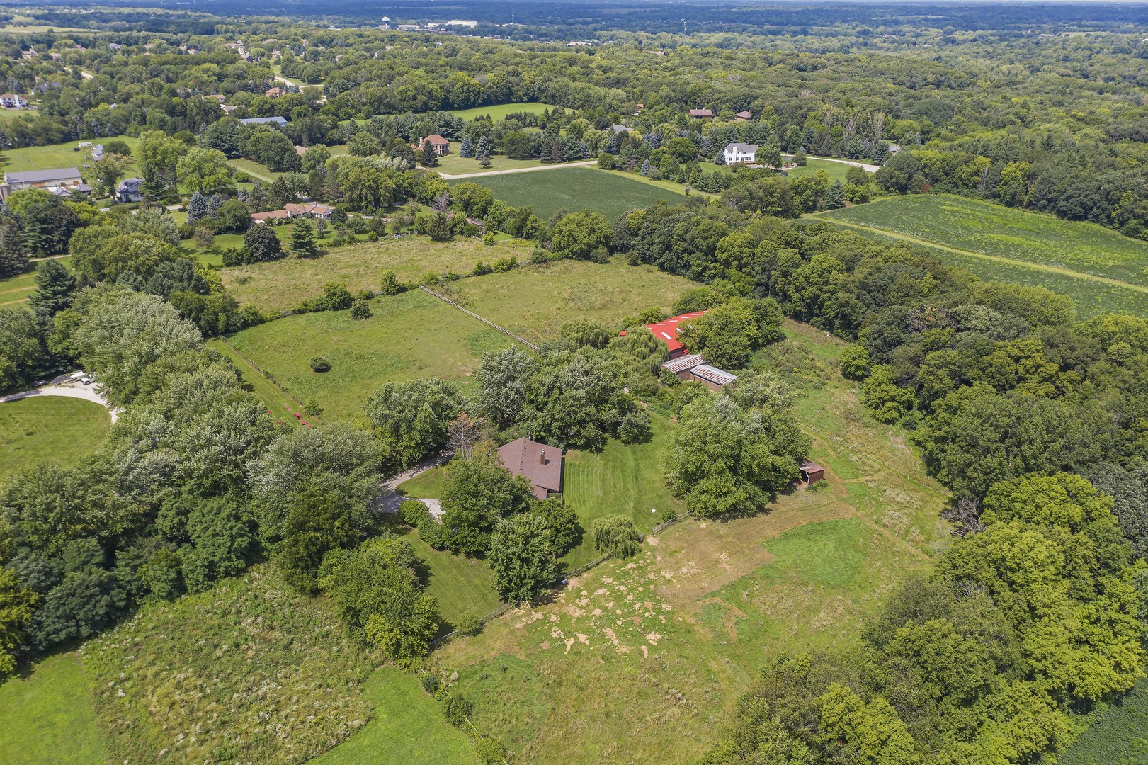 1010 Sunset Road Spring Grove, IL 60081 - Photo 9 of 40 a view of a garden with a lot of flower plants and wooden fence