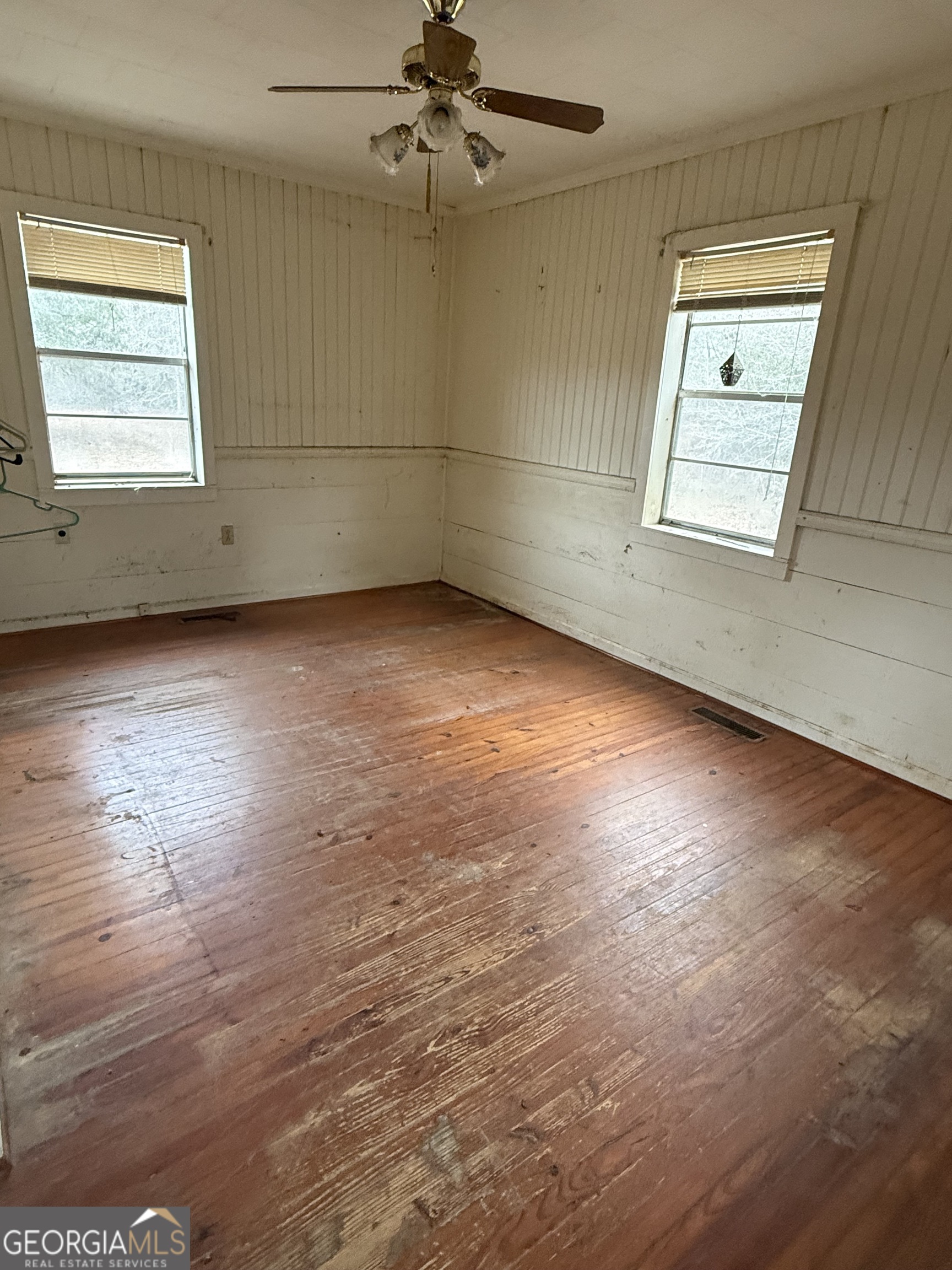 140 Keas Church Circle Adrian, GA 31002 - Photo 22 of 26 an empty room with wooden floor and windows