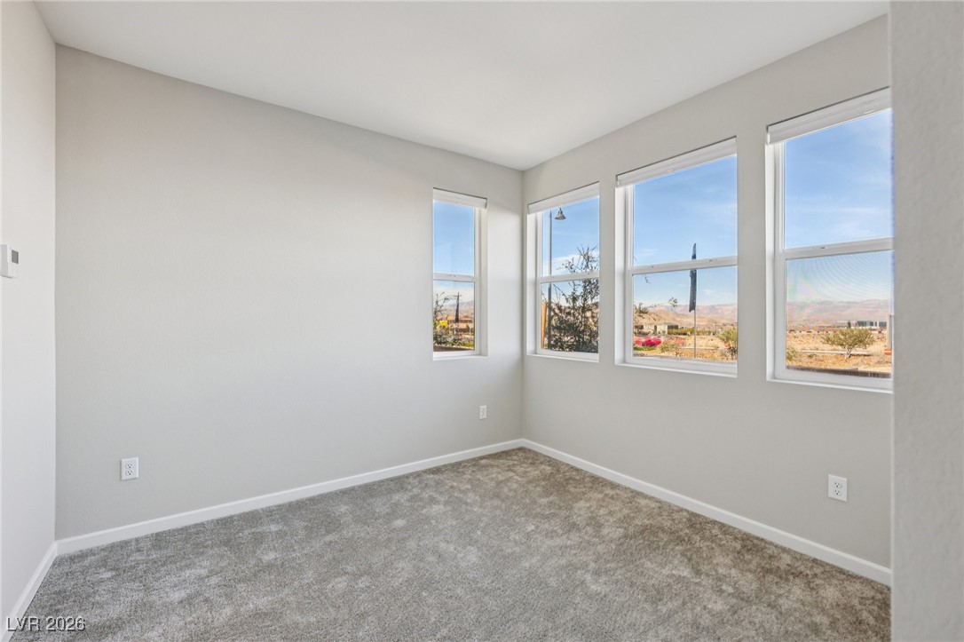 3338 Esker Rdg Avenue Henderson, NV 89044 - Photo 20 of 84 Carpeted spare room with baseboards