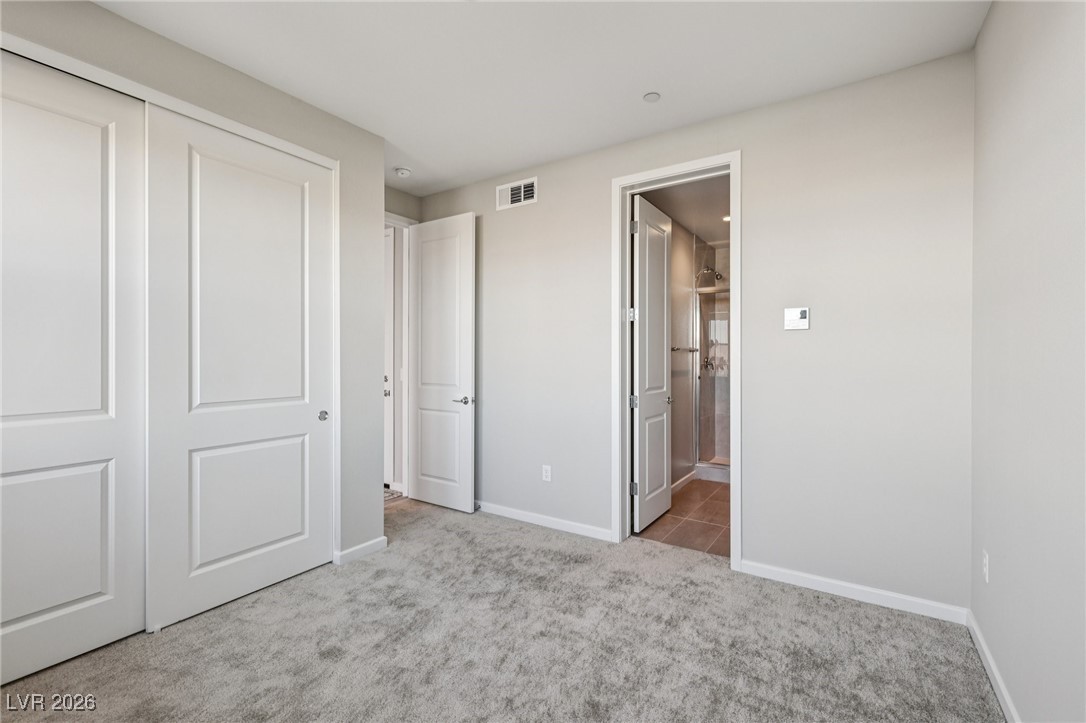 3338 Esker Rdg Avenue Henderson, NV 89044 - Photo 22 of 84 Unfurnished bedroom with a closet, connected bathroom, and light colored carpet