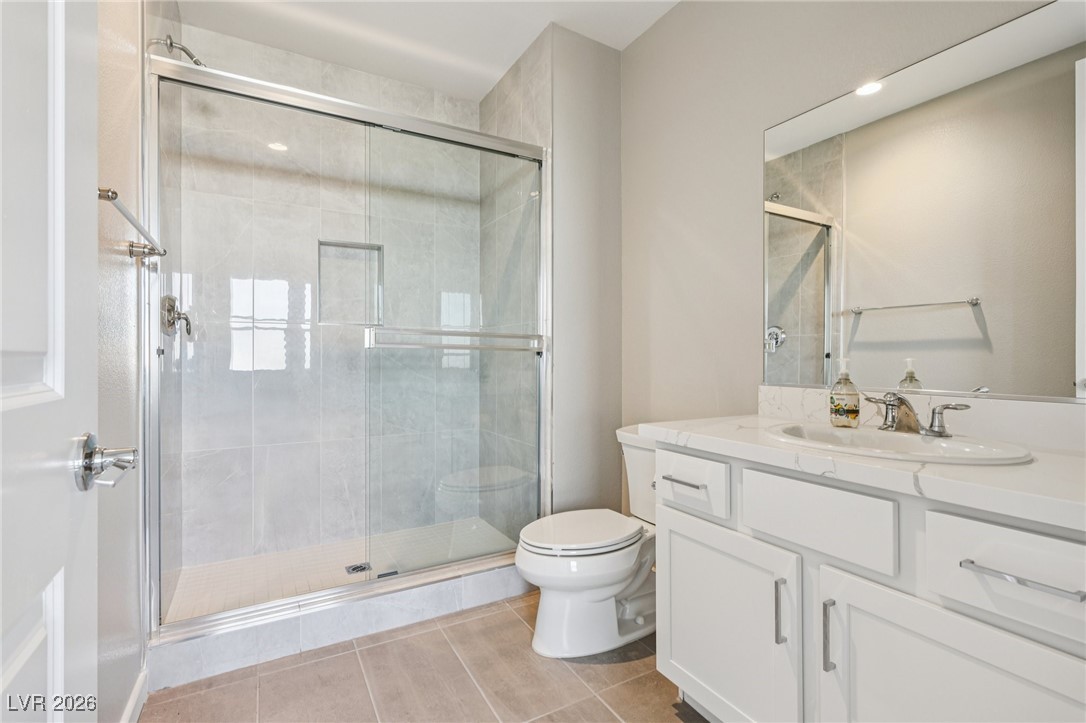 3338 Esker Rdg Avenue Henderson, NV 89044 - Photo 24 of 84 Bathroom featuring vanity, a shower stall, and light tile patterned flooring
