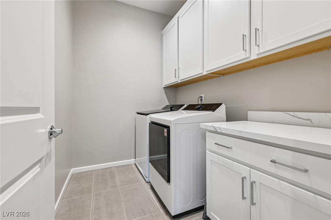 3338 Esker Rdg Avenue Henderson, NV 89044 - Photo 29 of 84 Washroom featuring cabinet space, washing machine and clothes dryer, and light tile patterned floors