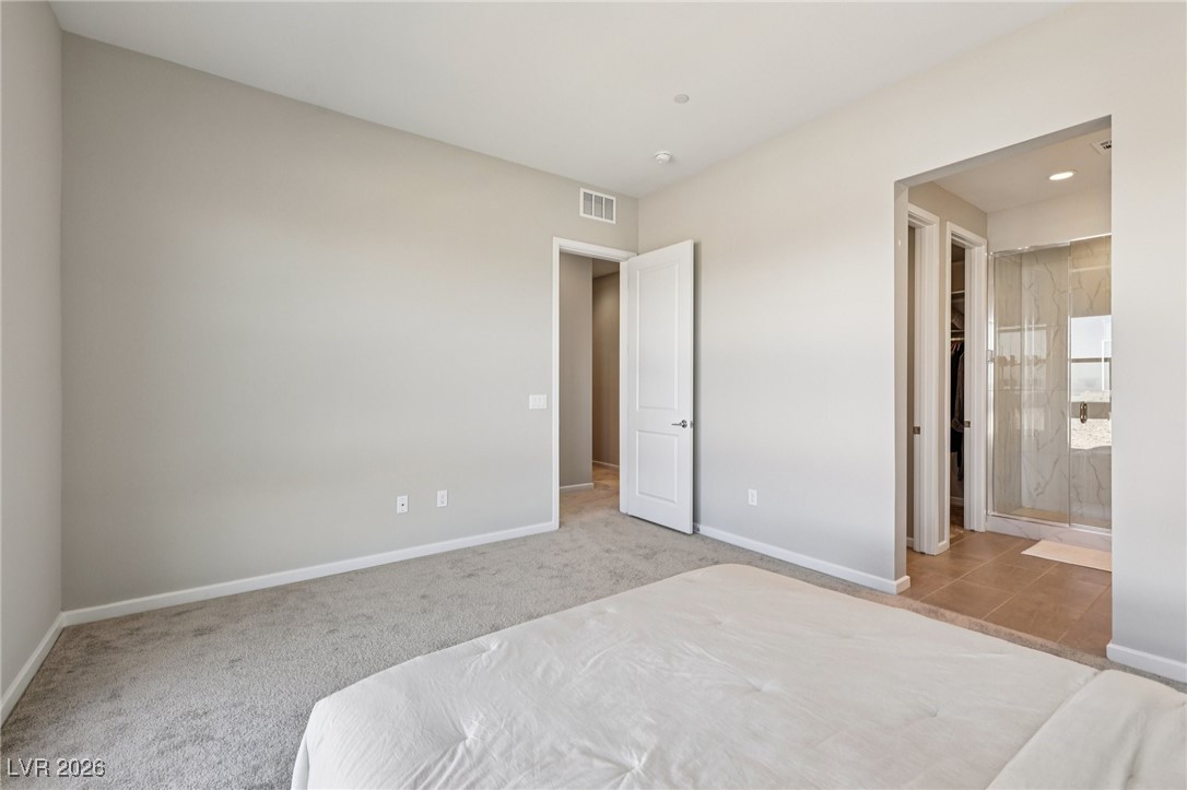 3338 Esker Rdg Avenue Henderson, NV 89044 - Photo 32 of 84 Unfurnished bedroom with ensuite bath, light colored carpet, and recessed lighting
