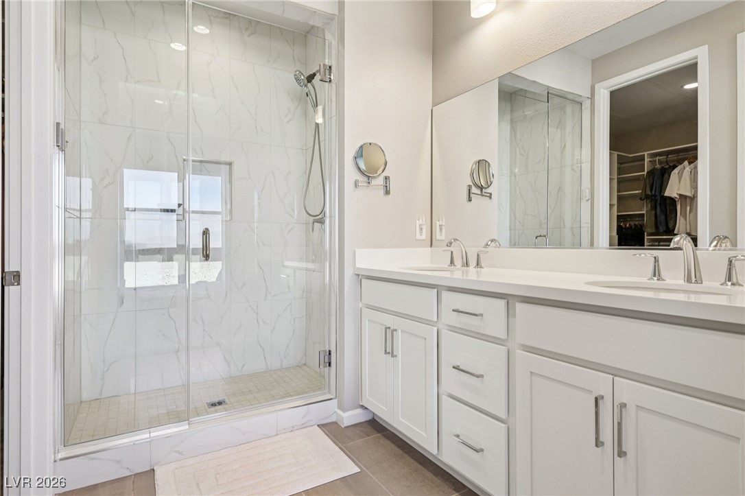 3338 Esker Rdg Avenue Henderson, NV 89044 - Photo 37 of 84 Bathroom with double vanity, a marble finish shower, and a spacious closet