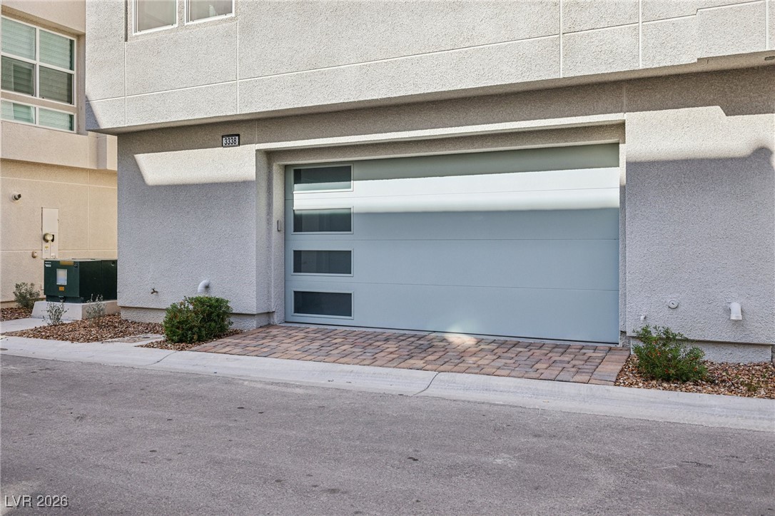 3338 Esker Rdg Avenue Henderson, NV 89044 - Photo 4 of 84 Doorway to property featuring stucco siding, an attached garage, and driveway