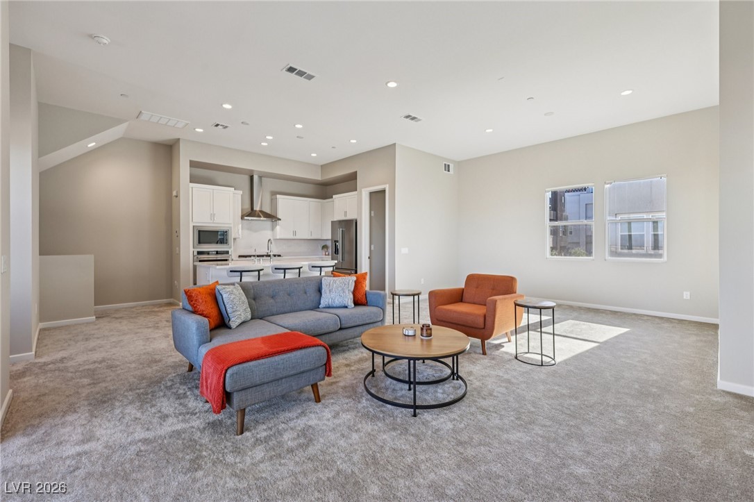3338 Esker Rdg Avenue Henderson, NV 89044 - Photo 6 of 84 Living area featuring light carpet and recessed lighting