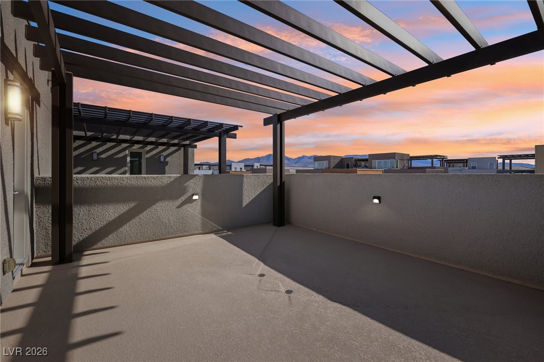 3338 Esker Rdg Avenue Henderson, NV 89044 - Photo 70 of 84 Patio terrace at dusk featuring a patio area and a residential view