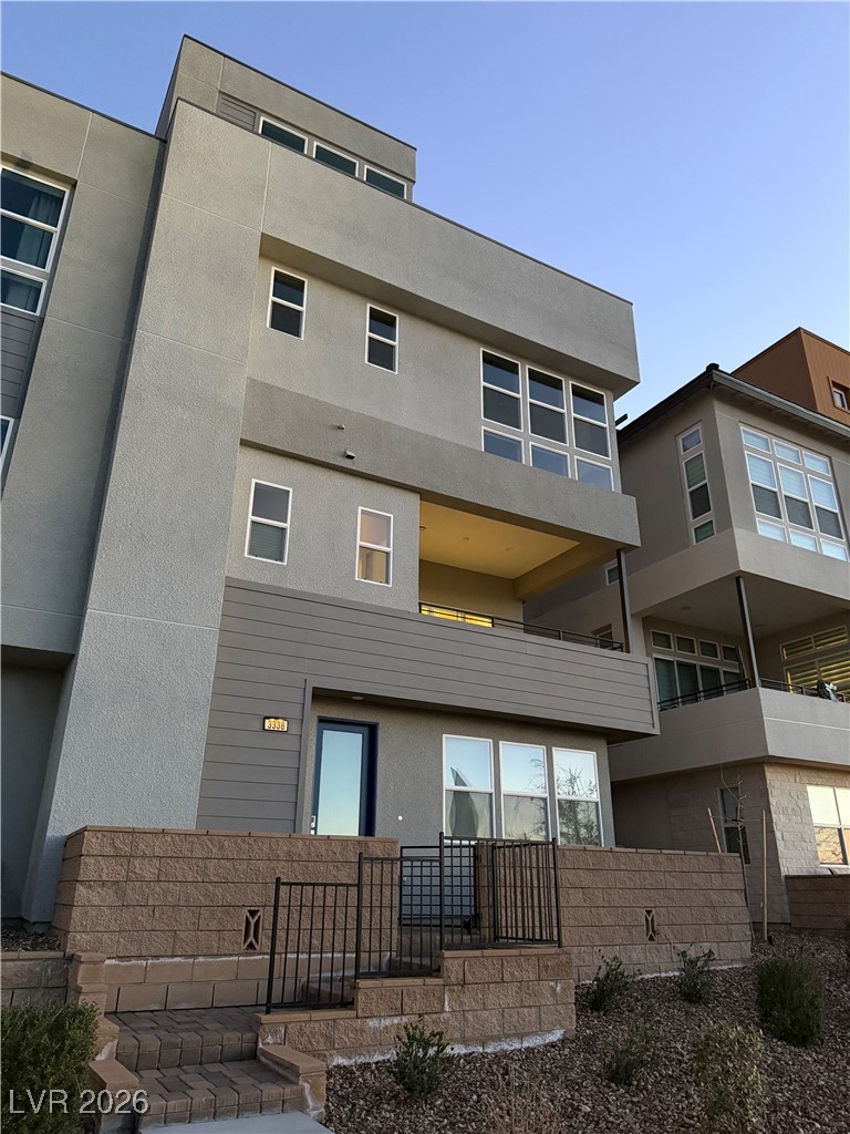 3338 Esker Rdg Avenue Henderson, NV 89044 - Photo 73 of 84 Back of house with a balcony and stucco siding