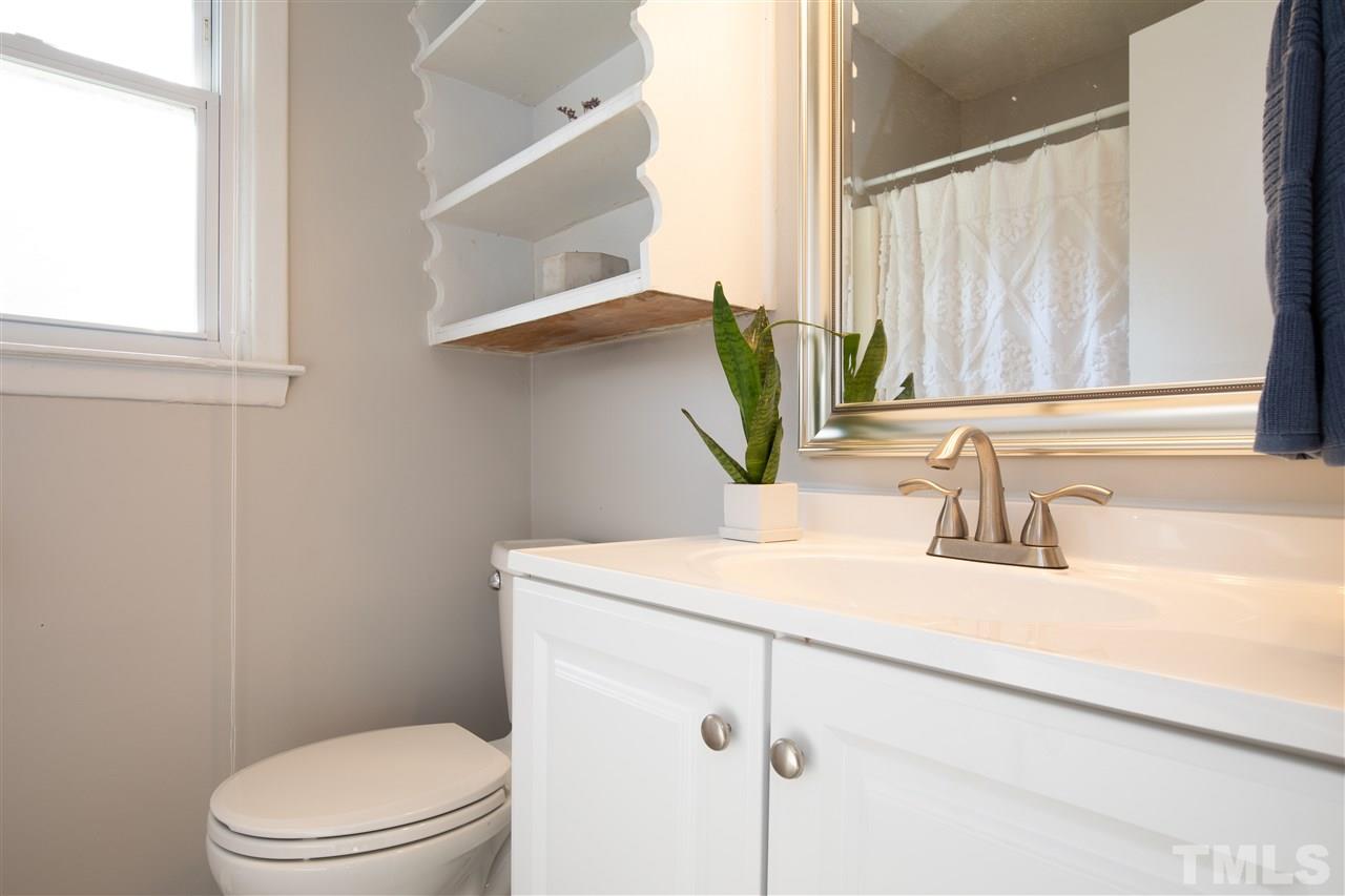 4005 Lizard Lick Road Wendell, NC 27591 - Photo 12 of 25 a bathroom with a sink a toilet and a mirror
