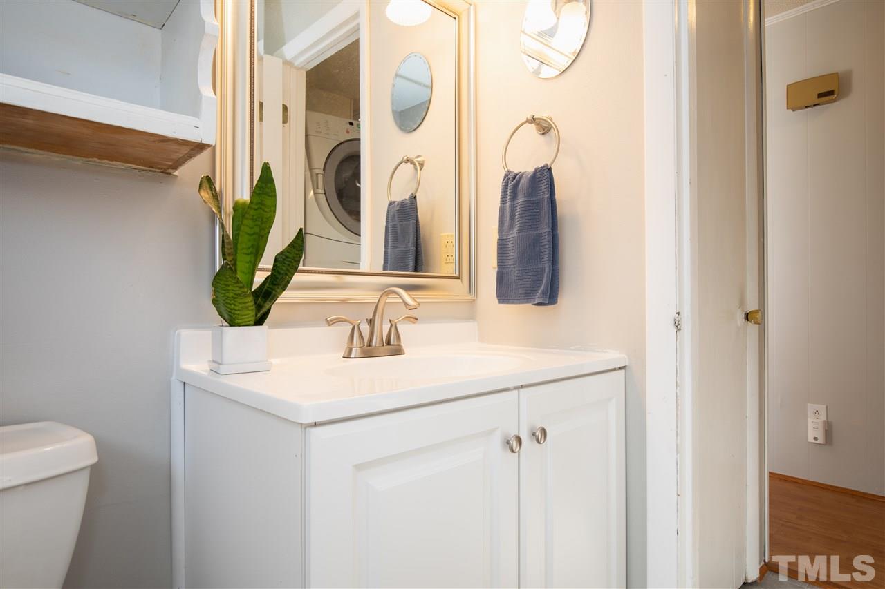 4005 Lizard Lick Road Wendell, NC 27591 - Photo 13 of 25 a bathroom with a sink vanity and a mirror