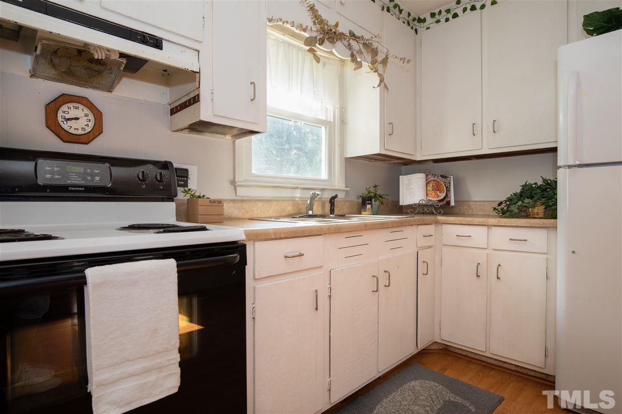 4005 Lizard Lick Road Wendell, NC 27591 - Photo 18 of 25 a kitchen with stainless steel appliances granite countertop a sink and cabinets