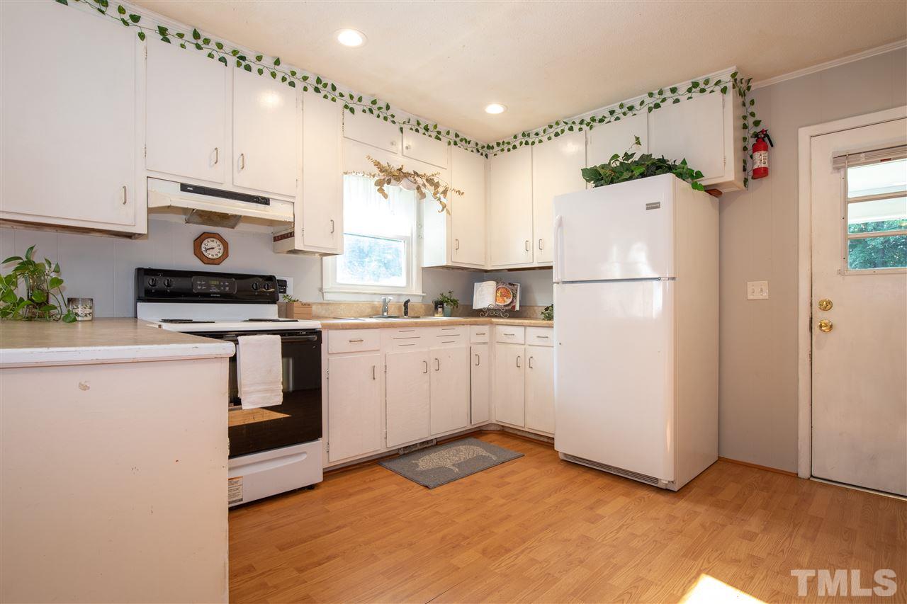 4005 Lizard Lick Road Wendell, NC 27591 - Photo 19 of 25 a kitchen with white cabinets and white appliances