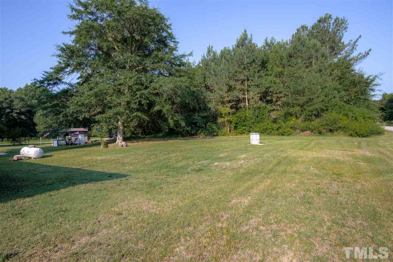 4005 Lizard Lick Road Wendell, NC 27591 - Photo 20 of 25 a view of a field with trees in the background