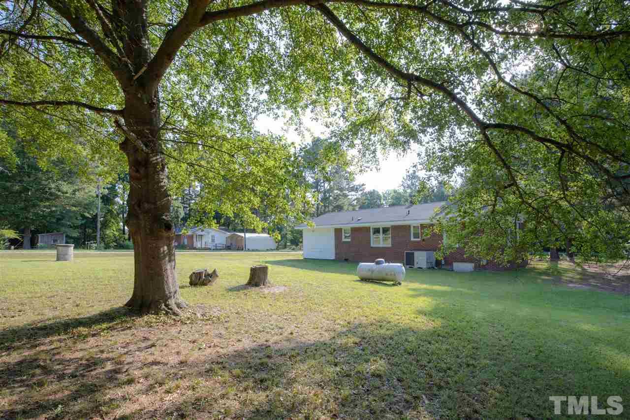 4005 Lizard Lick Road Wendell, NC 27591 - Photo 22 of 25 a view of a house with a yard and large tree
