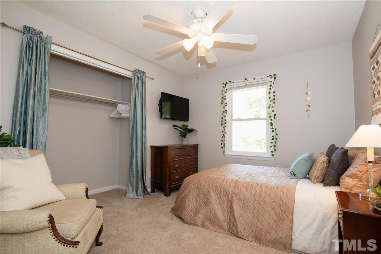 4005 Lizard Lick Road Wendell, NC 27591 - Photo 10 of 25 a bedroom with a large bed and a flat tv screen