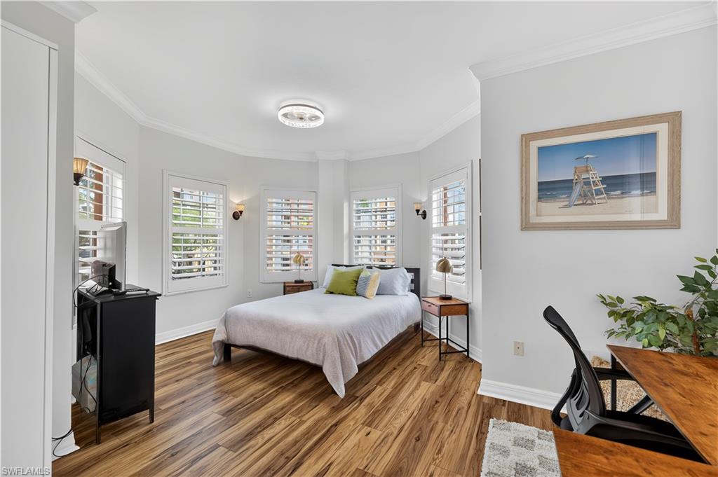 450 Bayfront Place, Unit 4202 Naples, FL 34102 - Photo 14 of 39 Bedroom with crown molding, wood finished floors, and multiple windows