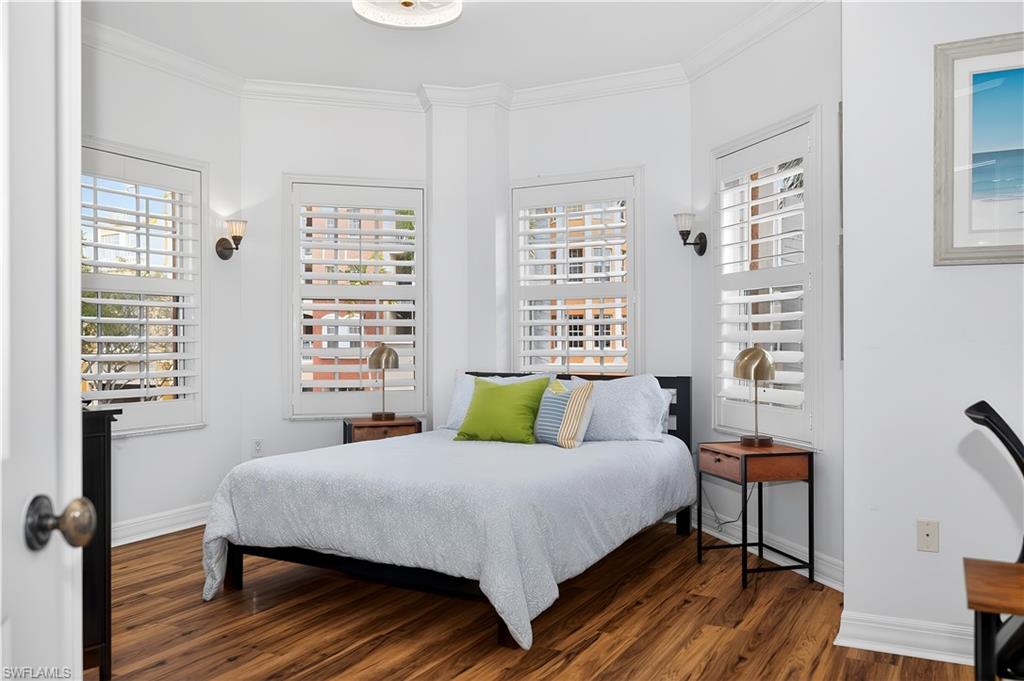 450 Bayfront Place, Unit 4202 Naples, FL 34102 - Photo 15 of 39 Bedroom featuring crown molding and wood finished floors