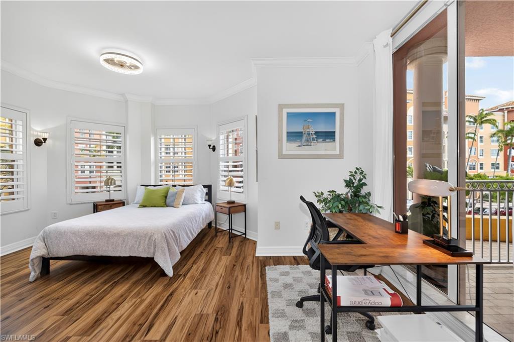 450 Bayfront Place, Unit 4202 Naples, FL 34102 - Photo 16 of 39 Bedroom featuring wood finished floors, crown molding, a desk, and access to outside