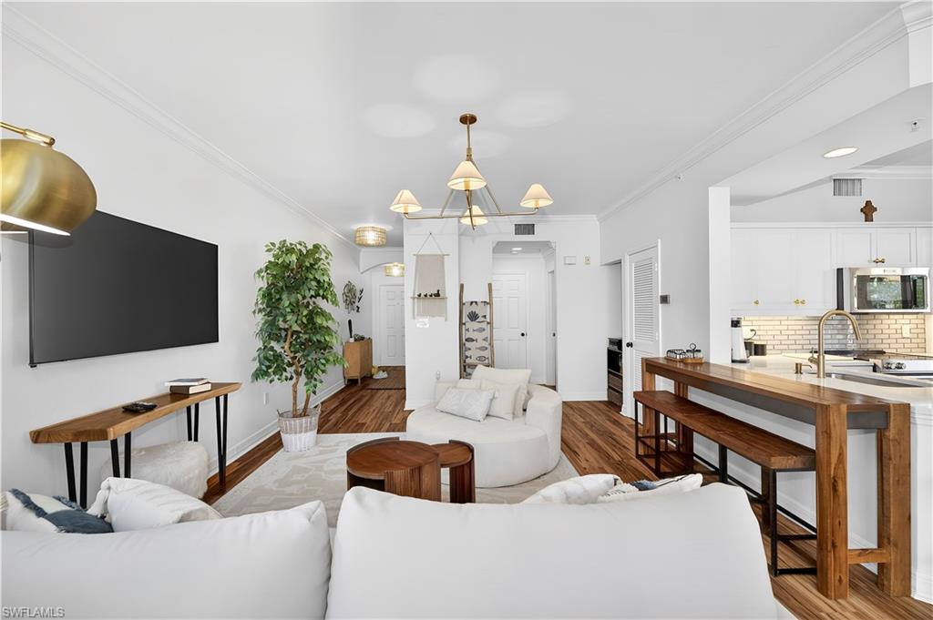 450 Bayfront Place, Unit 4202 Naples, FL 34102 - Photo 3 of 39 Living room featuring crown molding and wood finished floors