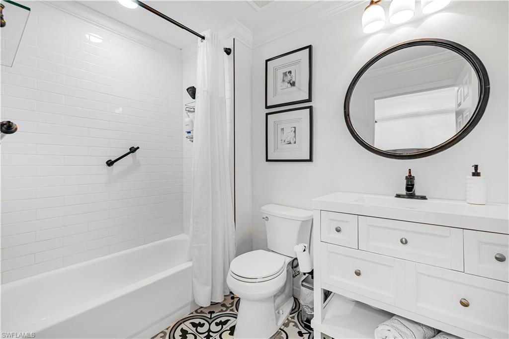 450 Bayfront Place, Unit 4202 Naples, FL 34102 - Photo 7 of 39 Bathroom featuring vanity, crown molding, and shower / bathtub combination with curtain