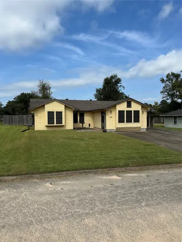 a front view of a house with a garden