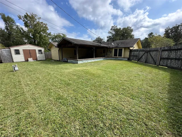 a view of an empty room with a chandelier fan