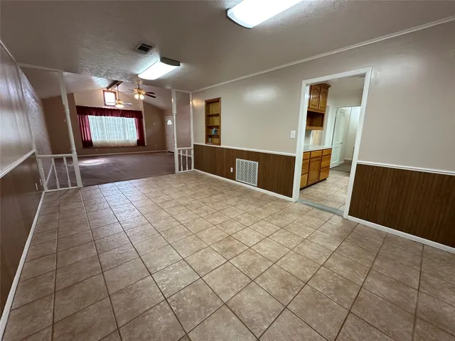a large room with closet and windows